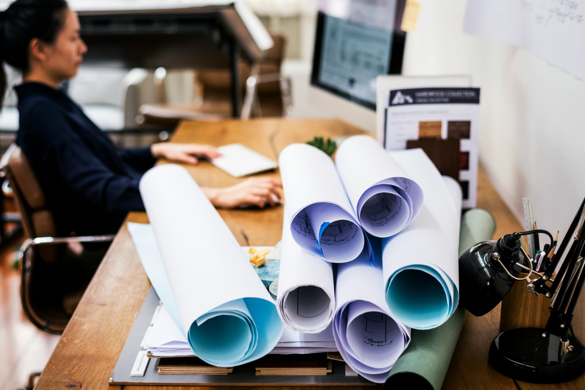 Illustration of a bid manager reviewing plans before submitting a proposal